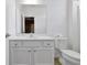 Bright, all-white bathroom with a modern vanity and mirror at 3860 Sonoma Blvd, Kissimmee, FL 34741