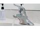 Chrome bathroom faucet with running water, set on a white countertop at 3860 Sonoma Blvd, Kissimmee, FL 34741