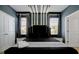 Well-appointed bedroom with decorative lighting fixtures and comfortable furnishings at 3860 Sonoma Blvd, Kissimmee, FL 34741