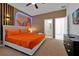 Spacious bedroom with stylish headboard, en-suite bathroom, and modern furnishings at 3860 Sonoma Blvd, Kissimmee, FL 34741