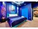 Beautifully themed bedroom with blue walls, a queen bed, and coordinated furnishings at 3860 Sonoma Blvd, Kissimmee, FL 34741