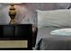 Comfortable bedroom featuring a muted color palette and a decorative lamp at 3860 Sonoma Blvd, Kissimmee, FL 34741
