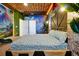 Bedroom with dinosaur themed mural, Jurassic Park sign, custom ceiling and dark green walls at 3860 Sonoma Blvd, Kissimmee, FL 34741