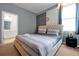 Bedroom featuring plush bedding, modern decor, and an en suite bathroom at 3860 Sonoma Blvd, Kissimmee, FL 34741