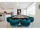 Elegant dining room featuring a long table, velvet chairs, pendant lighting, and modern decor at 3860 Sonoma Blvd, Kissimmee, FL 34741