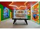 Air hockey table inside the vibrant game room with neon lights and Mario Kart themed decor at 3860 Sonoma Blvd, Kissimmee, FL 34741