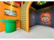 Gaming console area featuring a mounted TV and playful Mario themed decorations on the walls at 3860 Sonoma Blvd, Kissimmee, FL 34741