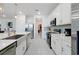 Modern kitchen with white cabinets, stainless appliances, and marble floors offers style and functionality at 3860 Sonoma Blvd, Kissimmee, FL 34741