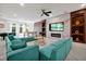 A spacious living room boasts a cozy fireplace, stylish sectional sofa, pool table, and a ceiling fan at 3860 Sonoma Blvd, Kissimmee, FL 34741