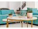 Stylish marble tables with gold wire decor and succulent plants next to a teal sectional sofa at 3860 Sonoma Blvd, Kissimmee, FL 34741