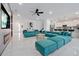 A vast open-concept living space featuring marble floors and a contemporary teal sectional sofa at 3860 Sonoma Blvd, Kissimmee, FL 34741