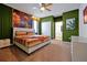 Stylish main bedroom with a ceiling fan, walk in closet, and an accent wall at 3860 Sonoma Blvd, Kissimmee, FL 34741