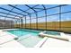 Beautiful swimming pool and spa with clear blue water inside the screened-in enclosure at 3860 Sonoma Blvd, Kissimmee, FL 34741