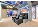 Fully furnished home theater with tiered seating and space-themed wall coverings at 3860 Sonoma Blvd, Kissimmee, FL 34741