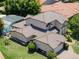 Aerial shot of the home showcasing tile roof, landscaping and a private screened-in pool area at 4019 Lake Mirage Blvd, Orlando, FL 32817