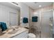 Clean bathroom featuring a glass-door shower, a toilet, a sink, and neutral tiling for a simple and functional design at 4019 Lake Mirage Blvd, Orlando, FL 32817