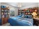 Cozy bedroom features custom bookshelves, and a ceiling fan, providing a peaceful atmosphere at 4019 Lake Mirage Blvd, Orlando, FL 32817