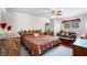 Relaxing bedroom with a window, ceiling fan, queen size bed, and wood furniture, creating a peaceful retreat at 4019 Lake Mirage Blvd, Orlando, FL 32817