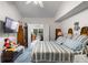 Spacious bedroom features a television, ceiling fan, a striped comforter, and a connecting study for added versatility at 4019 Lake Mirage Blvd, Orlando, FL 32817