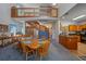 Open-concept dining area with a wooden table, staircase, and kitchen access for seamless entertaining at 4019 Lake Mirage Blvd, Orlando, FL 32817