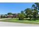 A charming two-story house with a well-manicured lawn, mature trees, and a spacious front yard at 4019 Lake Mirage Blvd, Orlando, FL 32817