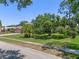 Manicured front lawn with mature trees and professional landscaping at 4019 Lake Mirage Blvd, Orlando, FL 32817