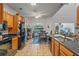 Spacious kitchen featuring wood cabinets, black appliances, and a breakfast nook with backyard views at 4019 Lake Mirage Blvd, Orlando, FL 32817