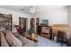 Comfortable living room features a ceiling fan, a sofa, a desk, and many bookshelves for organization at 4019 Lake Mirage Blvd, Orlando, FL 32817