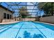 Large in-ground pool under screened enclosure, perfect for swimming and relaxation at 4019 Lake Mirage Blvd, Orlando, FL 32817