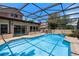 Inviting screened pool area featuring a cool blue pool, deck and a seating area for outdoor relaxation at 4019 Lake Mirage Blvd, Orlando, FL 32817
