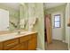 Bathroom featuring a unique hand-painted wall design, wooden cabinets, and a shower with peach colored curtain at 4571 Abaco Dr, Tavares, FL 32778