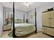 This bedroom features a four-poster bed, plush carpet, and light blue walls at 4571 Abaco Dr, Tavares, FL 32778