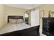 This bedroom features carpet, a black dresser, and a window at 4571 Abaco Dr, Tavares, FL 32778