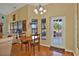 Cozy breakfast nook features a chandelier, wood floors, and natural light from windows at 4571 Abaco Dr, Tavares, FL 32778