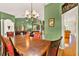 Formal dining room with a wooden table, red chairs, chandelier, and an open view to the living area at 4571 Abaco Dr, Tavares, FL 32778