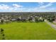 Expansive green sports field with soccer goals in a neighborhood featuring well-maintained homes at 4571 Abaco Dr, Tavares, FL 32778