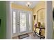 Bright foyer featuring a decorative glass door and a round table with ornate details at 4571 Abaco Dr, Tavares, FL 32778