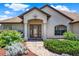 Welcoming front entrance with glass door, elegant columns, and a brick pathway surrounded by vibrant plants at 4571 Abaco Dr, Tavares, FL 32778