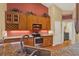 Bright kitchen boasts wood cabinets, granite countertops, and stainless-steel appliances at 4571 Abaco Dr, Tavares, FL 32778