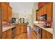 Traditional kitchen features wood cabinets, stainless appliances, granite countertops, and hardwood floors at 4571 Abaco Dr, Tavares, FL 32778