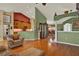 Open-concept living room features hardwood floors, vaulted ceiling, and access to the dining area at 4571 Abaco Dr, Tavares, FL 32778