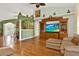 Bright living room boasts wood floors, high ceilings, and a large entertainment center at 4571 Abaco Dr, Tavares, FL 32778