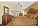 Spacious main bedroom features hardwood floors, a ceiling fan, and traditional furnishings at 4571 Abaco Dr, Tavares, FL 32778