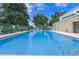 Community swimming pool featuring clear blue water, lounge chairs, and well-maintained pool area at 4571 Abaco Dr, Tavares, FL 32778