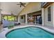 Inviting covered patio featuring a relaxing hot tub, bar area and comfortable seating; perfect for entertaining guests at 4571 Abaco Dr, Tavares, FL 32778