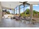 Bright sunroom with oversized picture windows, tiled floors, comfortable seating, and a view of lush greenery at 4571 Abaco Dr, Tavares, FL 32778