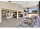 Spacious sunroom with tile floors, ceiling fans, comfortable seating, and a backyard view with a built in hot tub at 4571 Abaco Dr, Tavares, FL 32778