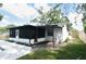 A partially screened patio leads to a spacious backyard at 5805 Hutton Dr, Orlando, FL 32808