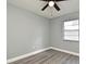 This bright bedroom features a ceiling fan with light and a sunny window overlooking the front yard at 5805 Hutton Dr, Orlando, FL 32808