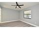 Cozy bedroom with light gray walls, new vinyl floors, a ceiling fan, and natural light from the window at 5805 Hutton Dr, Orlando, FL 32808